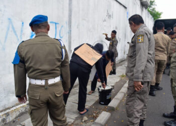 Lakukan vandalisme, dua pemuda kerja sosial mengecat tembok